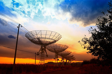 The silhouette of a radio telescope observatory