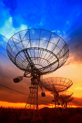 The silhouette of a radio telescope observatory