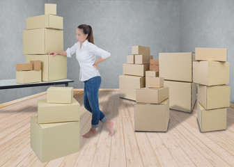 woman suffering from backache while moving boxes