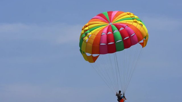 The tourist Flying on a parachute at patong beach
