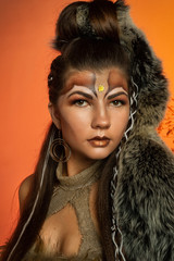 The girl in the image of the Amazon, with a fantasy make-up, posing in the studio. 
