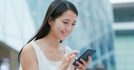 Woman use of mobile phone at business district