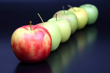 fresh different apples on dark background