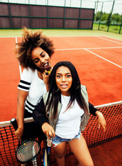 young pretty girlfriends hanging on tennis court, fashion stylis