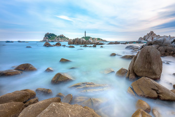 Ke Ga Lighthouse sunset with surf patted smoother reefs create clouds on the sea