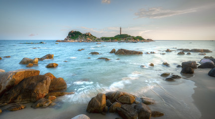 Ke Ga Lighthouse sunset with surf patted smoother reefs create clouds on the sea