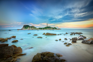 Ke Ga Lighthouse sunset with surf patted smoother reefs create clouds on the sea