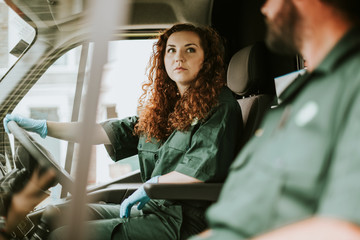 Paramedic woman driving an ambulance