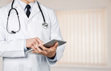 Young man doctor in white uniform with stethoscope