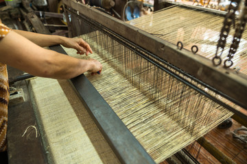 Weaving silk in traditional way in Vietnam. Vietnamese silk processing.