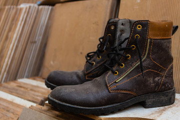 Pair of old boots on wooden background