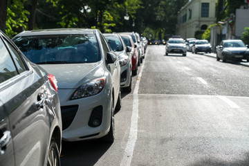 Fototapeta premium Parallel parking cars on urban street. Outdoor parking on road