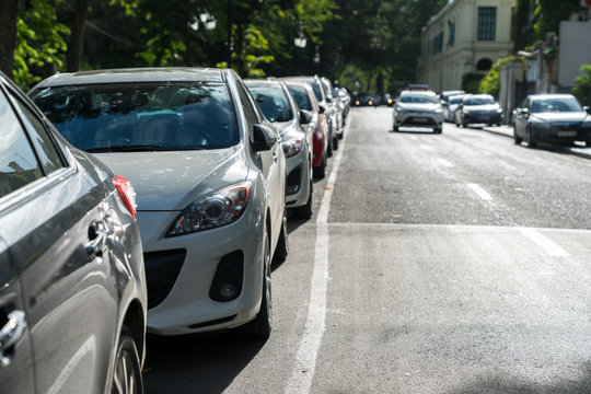 Parallel parking cars on urban street. Outdoor parking on road