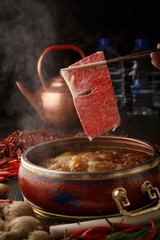 A piece of beef into the hot pot