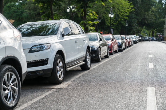 Parallel parking cars on urban street. Outdoor parking on road