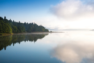 Morning view on foggy Shaori Lake at sunrise Georgia country