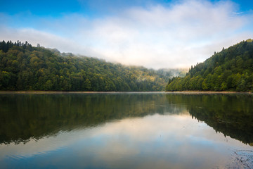 Morning view on foggy Shaori Lake at sunrise Georgia country
