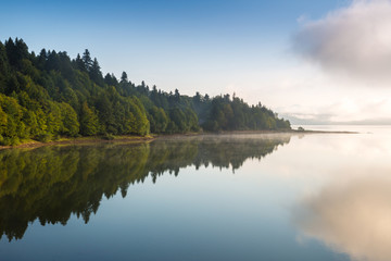 Morning view on foggy Shaori Lake at sunrise Georgia country