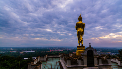 Great Golden Buddha statue at the"Wat Phra That Kao Noi" , Nan province, Thailand  with sky  Twilight time