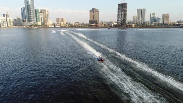 SHARJAH, U.A.E - DECEMBER 15 2017: Aerial view of speedboats making a fast turn during the race in Khalid lake in Sharjah, U.A.E.