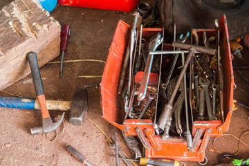 Wrench with tools messy and cluttered in box.