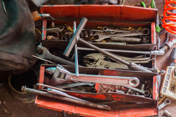 Wrench with tools messy and cluttered in box.
