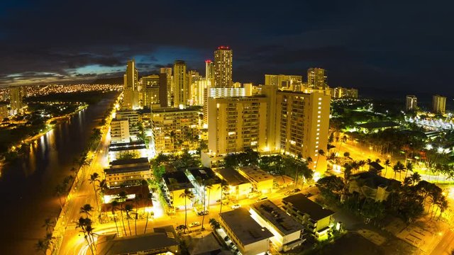 Zoom out night ot day timelapse of the city of Honolulu, Hawaii, USA