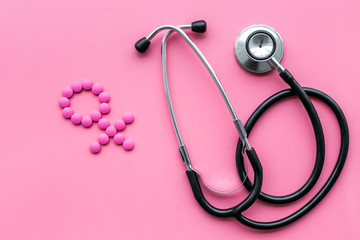 Female diseases concept. Stethoscope near female sign on pink background top view
