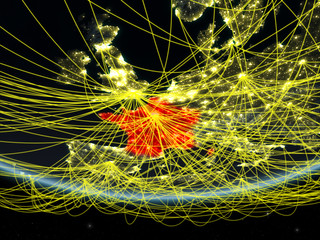 France on model of planet Earth at night with network representing travel and communication.