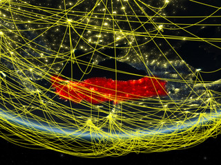 Turkey on model of planet Earth at night with network representing travel and communication.