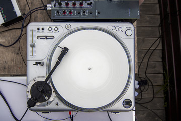 DJ turntable on the table top view. Mixing console.