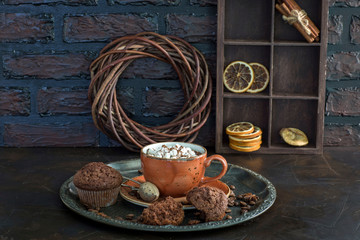 Hot chocolate with marshmallows and muffins on the table - background about dessert