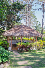 Fototapeta na wymiar Traditional gazebo roofed in palm tree mountains to enjoy the cool breeze and landscape