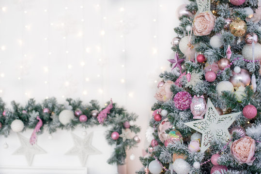 Decorated in a pink Christmas tree on a blurred, sparkling and fabulous background. Free space for text and greetings. New Year.