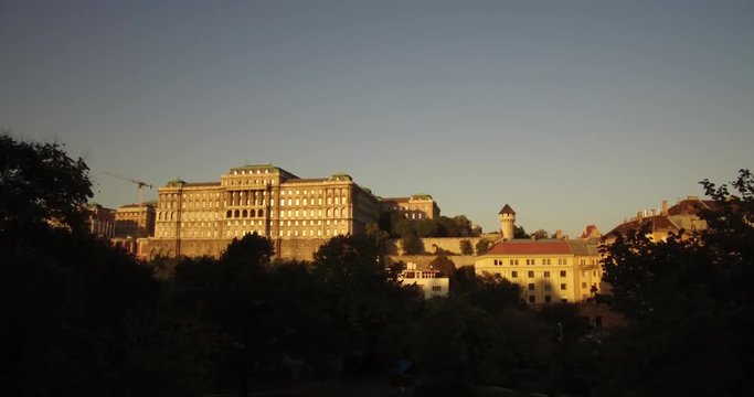 Dolly shot of the southwest part of the Buda Castle Hill from the Taban park on the slope of the Geller Hill in Budapest at sunset.