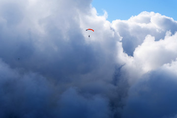 A parachute is near amazing clouds.