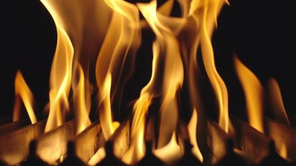 SLOW MOTION: Fire is burning and heats barbecue grill