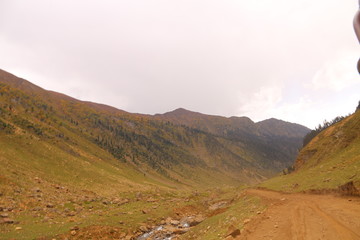 Track and river passing through between the big mountains