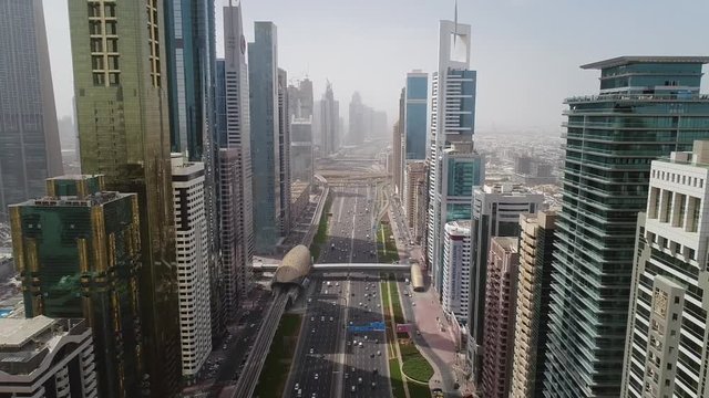Aerial view of Dubai colourful skyscrapers, and long busy road ,UAE.