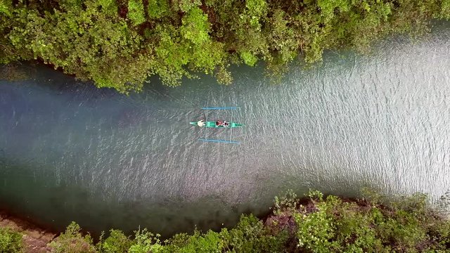 Aerial view of traditional fishing boat sailing in Bojo River, Aloguinsan, Philippines.