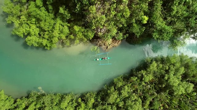 Aerial view above two traditional fishing boats sailing in Bojo River, Aloguinsan, Philippines.