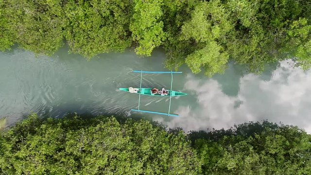 Aerial view of traditional fishing boat sailing in Bojo River, Aloguinsan, Philippines.