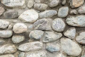 Old stone wall texture background close up