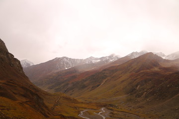 Scenery of high mountains with lake and high peak