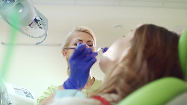 Dental hygienist check up patient teeth. Stomatology professional working with dental tools. Teeth treatment procedure in dental clinic. Doctor working with patient in dentist office