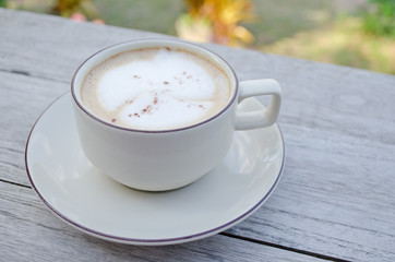 cappuccino coffee cup on old wood table