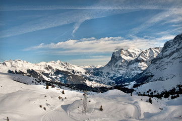 Fototapeta na wymiar Swiss Alps. View to the Grindelwald valley and ski tracks of Grindelwald ski-resort.
