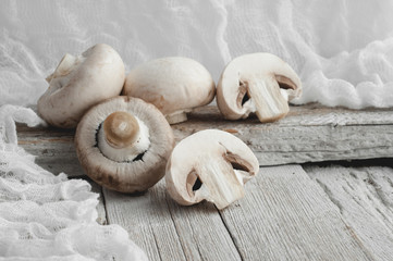Champignon mushrooms on a white wooden table