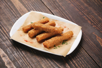 Fried bread sticks served on parchment paper