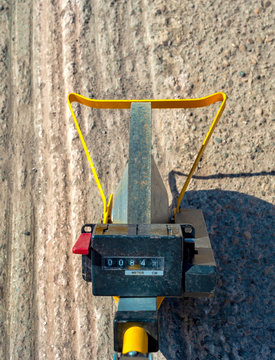 Close up measuring wheel (odometer) detects the length of an excavation of minitr